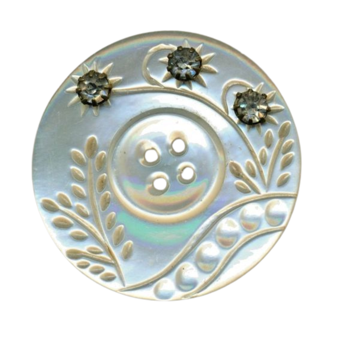a png of a white iridescent button. it has carved flowers on it.